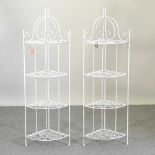 A pair of white painted metal corner plant stands