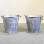 A pair of large round zinc planters