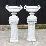 A pair of reconstituted stone garden urns