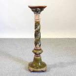 An early 20th century green glazed jardiniere stand