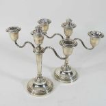 A pair of silver two branch table candelabra