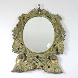An ornate gilt metal mirror