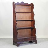 A reproduction mahogany waterfall bookcase