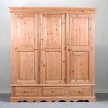 A modern pine triple wardrobe