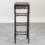 A 19th century Chinese carved rosewood jardinière stand