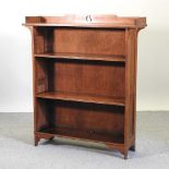 An Arts and Crafts light oak dwarf bookcase