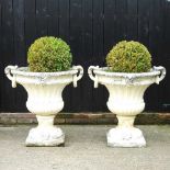A pair of large painted cast stone garden urns