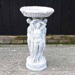 A reconstituted stone bird bath