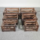 Two sets of three brown apple crates