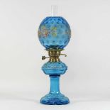 A 19th century blue glass and painted oil lamp