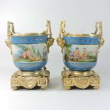 A pair of ornate Sevres style cache-pots