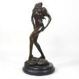 A bronze figure of a standing nude lady