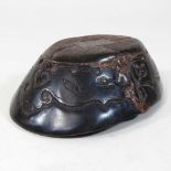 An oriental style carved horn paperweight
