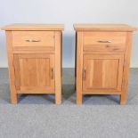 A pair of modern light oak bedside cabinets