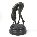A bronze figure of a nude lady