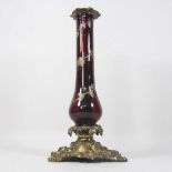 An ornate 19th century ruby glass lamp base