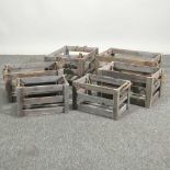 Two sets of three grey apple crates