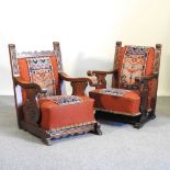 A pair of carved oak open armchairs