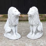 A pair of cast stone seated lions