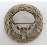 Scottish Plaid Brooch cast white metal, circular disk with antler decoration. Central, overlaid,