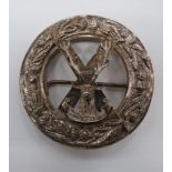 Highland Brigade Plaid Brooch cast silvered circlet plaid with thistle decoration.  Central cross