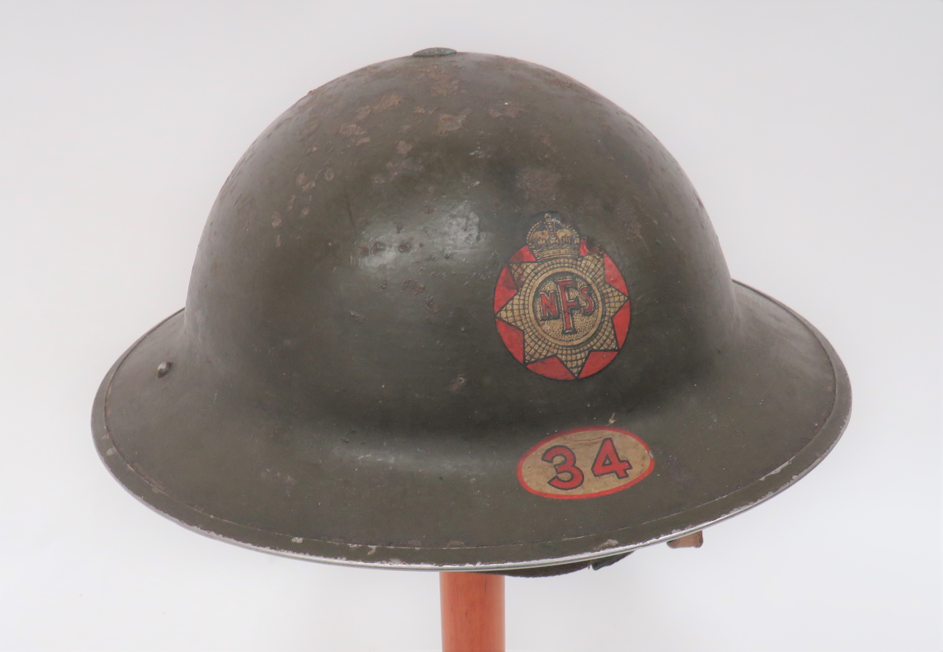 1939 Dated NFS District 34 (London Ealing) Steel Helmet khaki green painted outer shell.  The