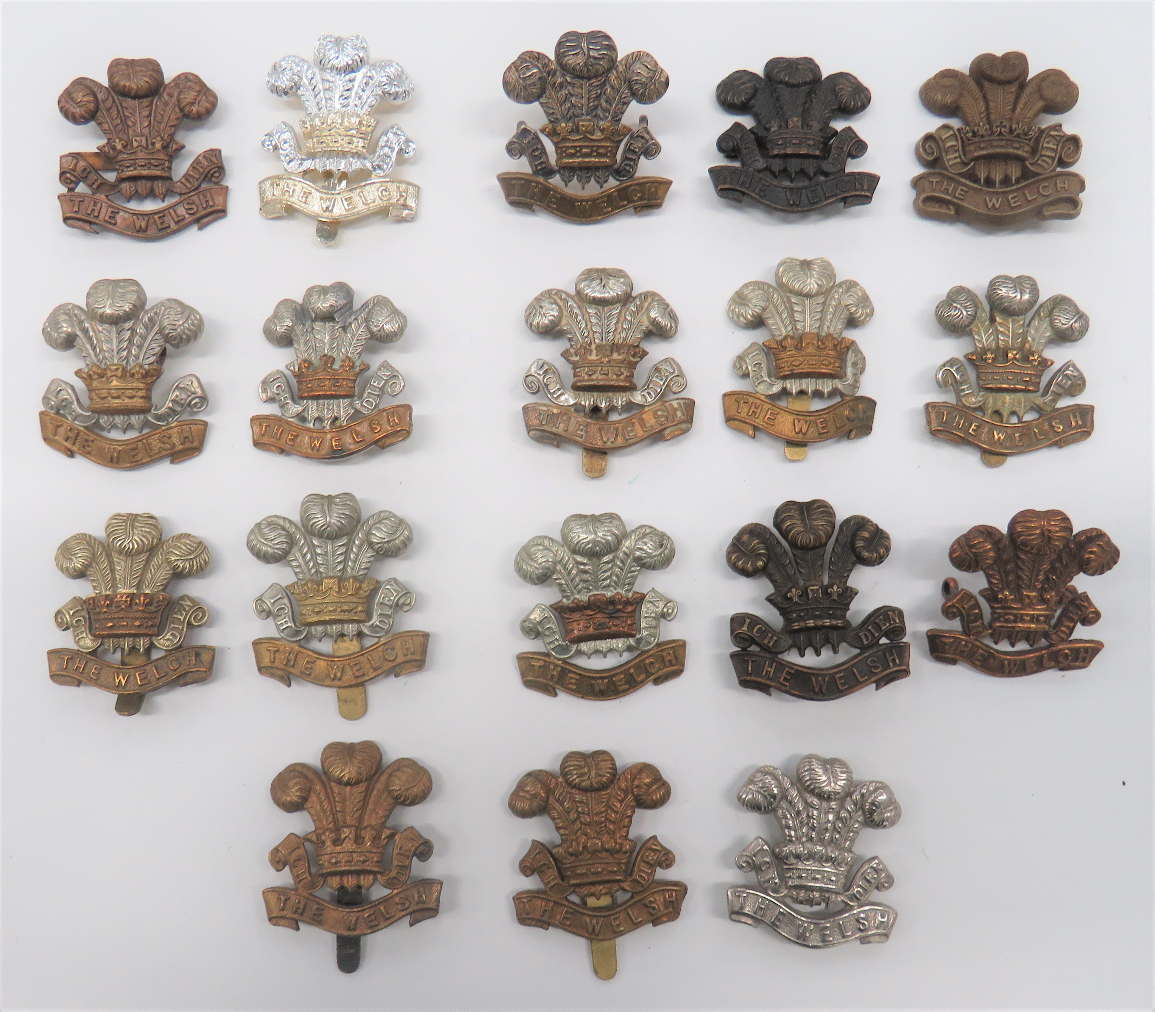 Welsh Regiment Cap Badges including WW2 plastic economy (blades) ... Blackened Welsh (lugs) ...