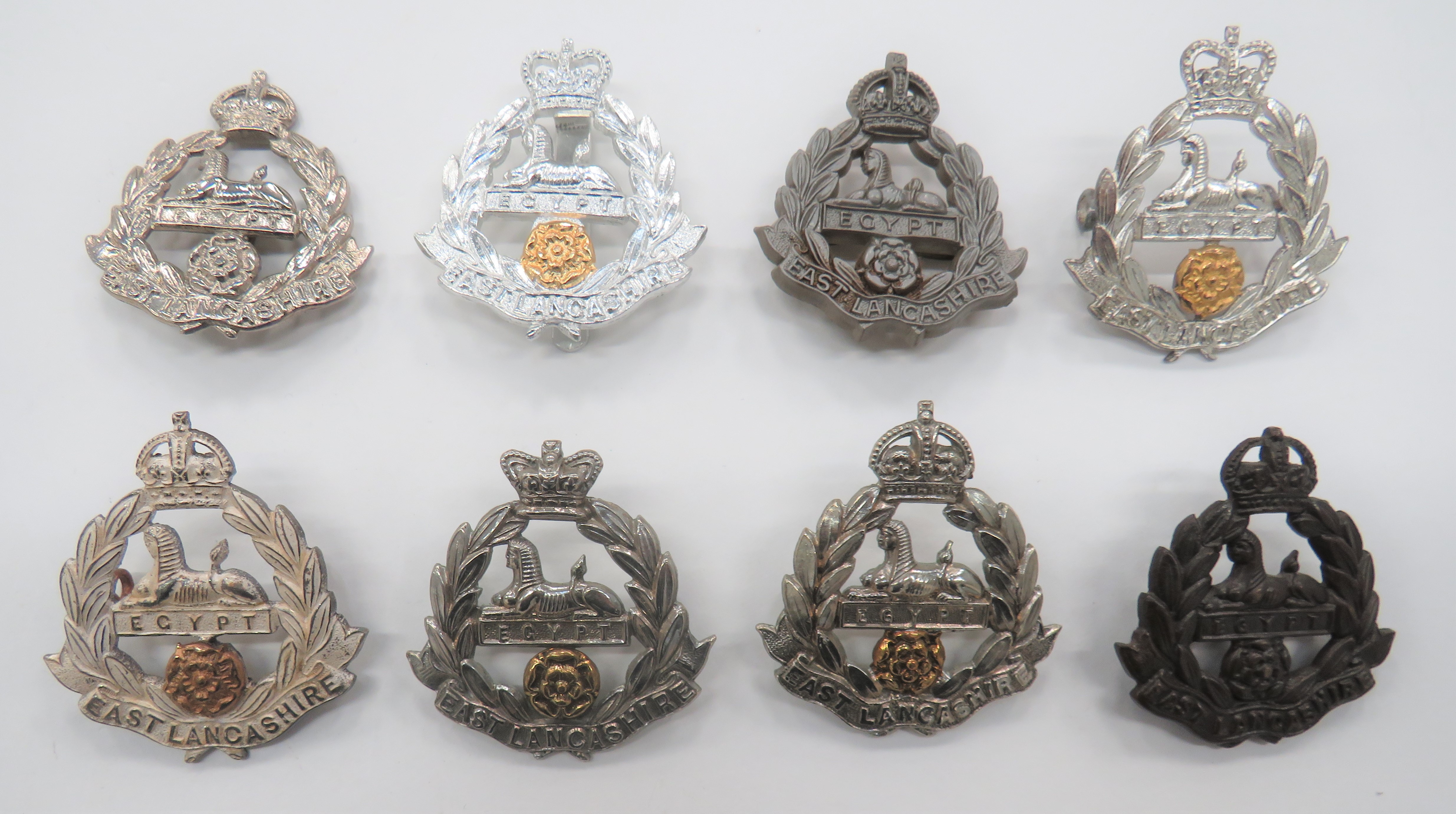 East Lancashire Cap Badges including bi-metal, Vic crown (lugs) ... Bronzed KC (blades) ... Silvered