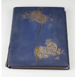 A Victorian scrap book, the blue leather and gilt scrap book opening to reveal cut out flowers and