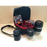 A cased set of three Minolta 35mm. camera lenses, comprising an AF 75-300 macro; an AF 50 macro; and