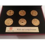A cased corporate gift set of six gold plated Dilmun Seals.,
