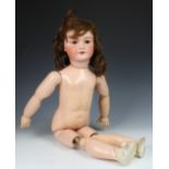 A large German bisque head doll, stamped '12', with weighted dark brown eyes, real hair lashes and