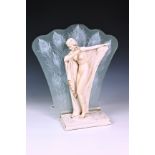 An Art Deco style figural resin lamp base, of a nude female on marble style base with shaped glass