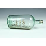 A 19th century ship in bottle, 1890s, U.S "UNA" three masted ship with cutter alongside, 9½in. (24.