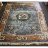 A large Chinese wool rug, second half 20th century, the central square medallions with a peacock and