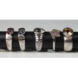 A collection of five silver rings set with various gemstones, comprising citrine; diamond & pink