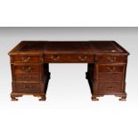 A 19th century style mahogany inverted breakfront partner's desk, 20th century, the top with inset