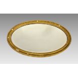 A Victorian oval gilt mirror, with bevelled plate, some losses.