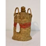 A empty one gallon flagon of Royal Navy rum, salt glazed cask in wicker cradle with twin-carrying
