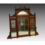 An Edwardian walnut overmantel mirror, 44¼in. (112.5cm.) high, 47½in. (120.75cm.) wide, polish