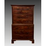 A George III mahogany chest on chest, the flared cornice over two short and three long graduated
