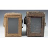 Two carriage clock morocco leather travelling cases, both of typical form with front window, the