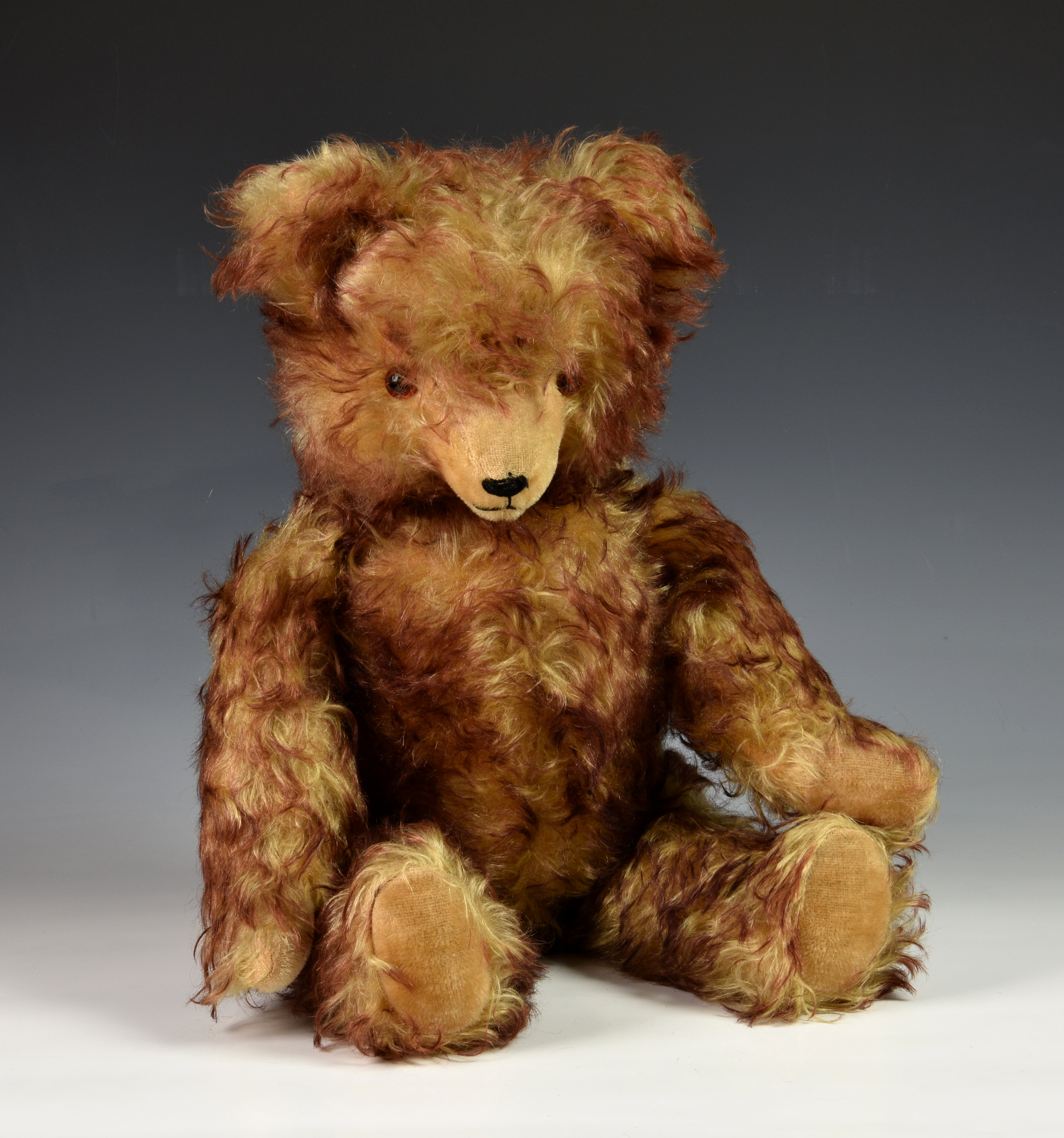 A vintage unknown growling teddy bear, possibly Hermann, fully jointed, having long snout, orange