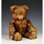 A vintage unknown growling teddy bear, possibly Hermann, fully jointed, having long snout, orange