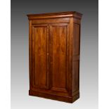 A French antique mid-oak two door armoire, the ogee cornice over a pair of panelled doors