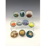 Seven glass paperweights, to include Caithness 'Celebration' & 'Pebble', together with three resin