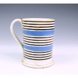 A mocha ware tankard, early 20th century, four spot dentrical design on mocha ground with bands of