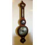 A mid-19th century mahogany wheel barometer, with boxwood and ebony strung border, silvered