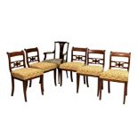 A set of five early 19th century mahogany label back dining chairs, with strung label top rail