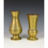 Two antique polished bronze vases, each of shaped form, one inscribed with initials 'IHS', the